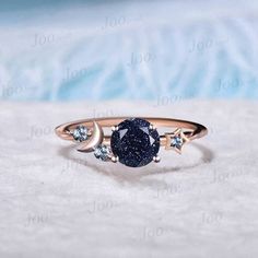 I LOVE YOU TO THE MOON BACK RING 1ct Round Cut Galaxy Starry Night Blue Goldstone Ring Cluster Alexandrite Wedding Ring Moon Star Design Unique Promise Ring Birthday Gifts Accept engrave the words inside the ring service: https://www.etsy.com/listing/1103764936/engrave-service HEALING RING : Blue Sandstone (also known as Blue Goldstone) symbolizes enterprise, success, victory, and glory, which enhance one's leadership and entrepreneurial skills. It is an excellent stone to meditate with before giving a speech or starting a new project. It is also very good at calming the senses and cleansing the chakras on all levels. Blue Sandstone bridges the gap between the earthly and spirit realms, so it is a great stone to use for contacting spirit guides or performing holistic healing. Blue Sandston Blue And Black Ring, Night Sky Jewelry, Space Themed Engagement Ring, Moon Promise Ring, Starry Engagement Ring, Galaxy Ring Engagement, Celestial Promise Crystal Ring, Starry Night Ring, Blue Celestial Moonstone Ring