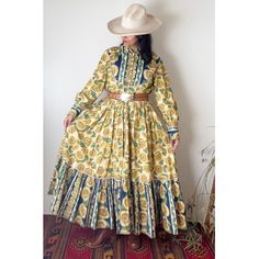 "A lovely vintage western inspired maxi dress has varying sunflower patterns with button up closures from the waist up and a voluminous skirt with ruffle detail. Also has an elastic waistband that has lost it's elasticity so a belt is highly recommended...it really does pull the look together! Also has side pockets. Zigzag stitching is used on all seams & hemline. This garment appears to be homemade by a skilled seamstress. Base feels like a cotton blend. **Western belt shown in photos is not included, not for sale.** Such a fun find!  Great Vintage Condition Best fits: MED - sizes 6 - 9/10 Length: 55.5\" Shoulder to Shoulder: 17\" Bust: 19\" Waist: 16.5\" Hips: open Model is 5'5 - U.S. size 4/6 Please review measurements & shop policies. Feel free to message me if you have questions about Rodeo Dresses, Cowgirl Dress, Cowgirl Dresses, Sunflower Dress, Voluminous Skirt, Western Vintage, Western Belt, Sunflower Pattern, Vintage Western