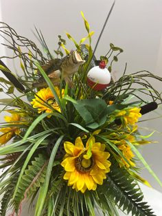 a vase filled with lots of different types of flowers and plants on top of a table