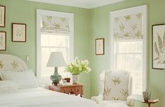 a bedroom with green walls and white furniture