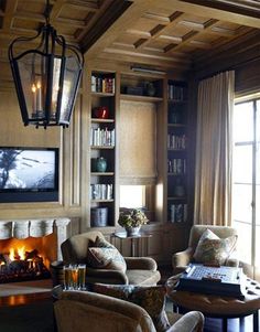 a living room filled with furniture and a fire place in front of a large window