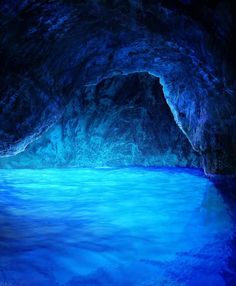 a blue cave with water inside it