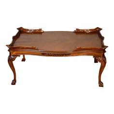 an ornately carved wooden coffee table with two trays on the top and bottom