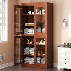 a wooden cabinet filled with lots of white towels