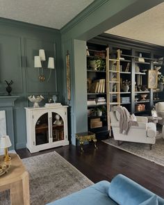 a living room filled with furniture and bookshelves next to a fire place in a fireplace