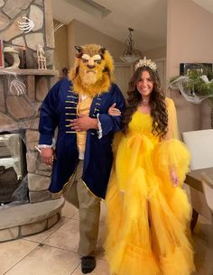 a man and woman dressed up as beast and princess in yellow dresses standing next to each other