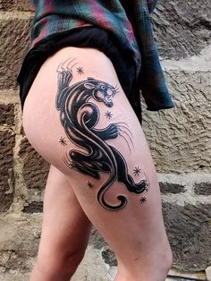 a woman's thigh with a tattoo on it