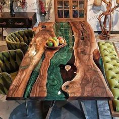 the table is made out of wood and has green velvet chairs