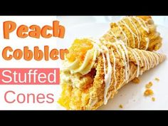 a white plate topped with two desserts covered in frosting and icing next to the words peach cobbler stuffed cones