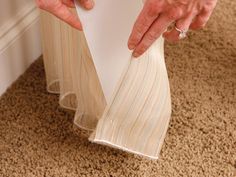 an older woman is holding papers on the floor