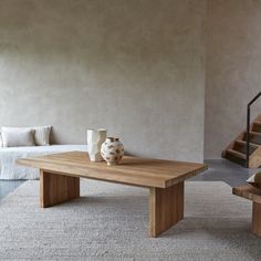 a wooden table sitting on top of a white rug