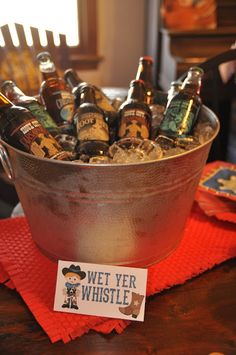 a metal bucket filled with lots of beer bottles