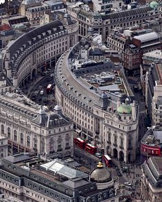 an aerial view of the city with many buildings and buses on it's sides