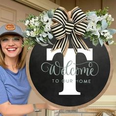 a woman standing next to a welcome sign