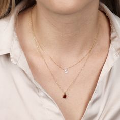 Take your style up a notch with this rich Garnet pendant-necklace. This stunning 4 prong cushion cut Garnet pendant is a perfect gift for her. Featuring 16"-18" adjustable gold chain. Gemstone Details: Gemstone : Garnet Stone Cut : Cushion, Color : Red Weight - 5x5mm Gold Details: Learn More 14 Karat Yellow Gold All colors of gold are nickel free and hypoallergenic. January Birthstone Jewelry, 14k Yellow Gold Necklace, Garnet And Gold, Solitaire Pendant Necklace, Tragus Earrings, Garnet Pendant, January Birthstone, Garnet Stone, Station Necklace