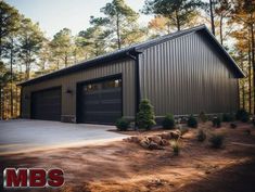 a large garage sits in the middle of a wooded area