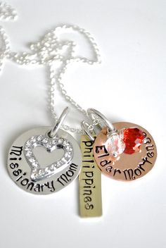 three different necklaces with names on them and one has a heart in the middle