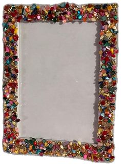 a square frame with many different colored stones on it