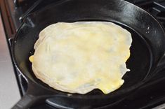 an omelet being cooked in a skillet on the stove