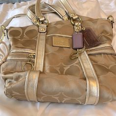 Very Gently Used. Stored In Dust Bag. Ships With Dust Bag Gold Satchel With Detachable Handle For On-the-go, Gold Double Handle Satchel For On-the-go, Gold Double Handle Shoulder Bag For On-the-go, Gold Shoulder Bag With Double Handle For On-the-go, Coach Gold Crossbody Satchel, Gold Coach Crossbody Satchel, Gold Travel Bag With Detachable Strap, Gold Bags With Handles For On-the-go, Gold Bags With Gold-tone Hardware For On-the-go