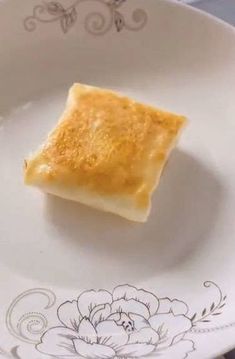 a square piece of food on a plate