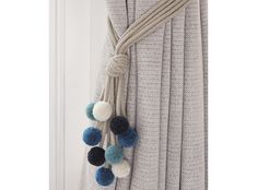 a curtain with pom - poms hanging from it