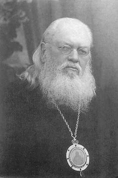 an old black and white photo of a man with a long beard wearing a chain around his neck