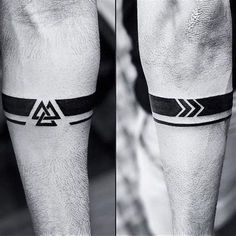 a man's leg with a black and white tattoo on it