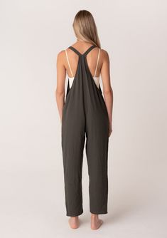 An oversize sleeveless lounge jumpsuit designed in soft cotton gauze. Cotton gauze Relaxed, oversize fit Sleeveless Long straight leg Racerback Side pockets Adjustable button straps Bohemian lounge jumpsuit Effortlessly cool and casual, our overalls-style jumpsuit is designed in soft cotton gauze. With a racerback detail and adjustable button straps. Perfect for lounging or running errands, we love to style it over a simple camisole tank top. Model is 5'9, wearing a size S.Style: I-73216W-RJZ Sleeveless Relaxed Jumpsuits And Rompers For Spring, Relaxed Sleeveless Jumpsuits And Rompers For Spring, Relaxed Sleeveless Jumpsuits For Spring, Sleeveless Jumpsuits And Rompers With Adjustable Straps For Loungewear, Overall Jumpsuits And Rompers With Adjustable Straps For Loungewear, Adjustable Straps Jumpsuit Overalls For Loungewear, Chic Cotton Overalls For Loungewear, Relaxed Summer Overalls And Rompers, Cotton Overalls With Adjustable Straps For Beach