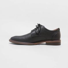 From formal meetings and events to family functions, these Leo Oxford Dress Shoes from Goodfellow & Co™ are a great pick to complete your ensemble. These medium-width shoes feature a cushioned footbed for comfy wear, making them great for both special occasion and everyday wear. With a sleek upper with stitched detailing and a lace-up front, they're perfect for creating a sharp, stylish look. Goodfellow & Co™: Where style & fit are always in good company. Formal Fitted Synthetic Oxfords, Classic Formal Lace-up Shoes With Ortholite Insole, Black Formal Oxfords With Cushioned Footbed, Black Cushioned Oxfords For Formal Wear, Synthetic Brogue Dress Shoes For Work, Plain Toe Synthetic Dress Shoes For Work, Formal Synthetic Lace-up Shoes With Plain Toe, Synthetic Plain Toe Dress Shoes For Work, Elegant Formal Dress Shoes With Cushioned Footbed