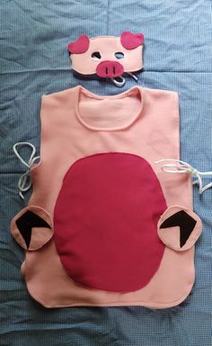 a child's pink and black shirt with an animal mask on top of it