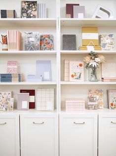 a white book shelf filled with lots of different types of cards and envelopes on top of it