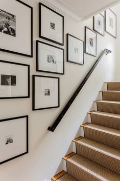 the stairs are lined with pictures and frames