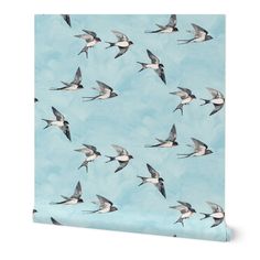 a flock of birds flying in the sky on a blue background wallpaper mural print