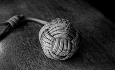 a ball of rope sitting on top of a wooden table