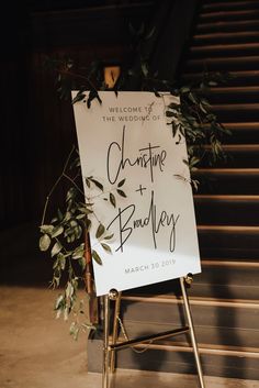 a welcome sign for the bride and groom to arrive at their wedding ceremony in front of some stairs