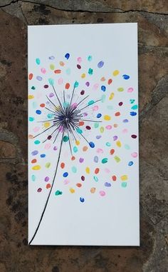 a card with confetti sprinkles on it sitting next to a stone wall