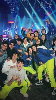 a group of young people posing for a photo in front of stage lights and spotlights