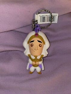 a keychain with a cartoon character on it's face and name tag