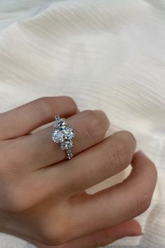 a woman's hand with a diamond ring on it