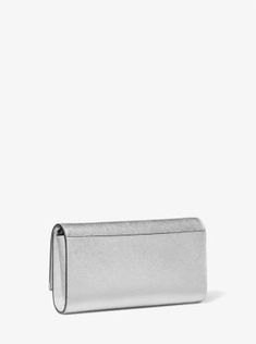 The sleek silhouette of our Mona clutch makes it a worthy investment. Crafted from metallic Saffiano leather, it’s accented with our Empire logo plaque and a detachable chain strap for hands-free wear. Inside, there’s just enough room for your keys, wallet and phone. Carry it in hand or slip it into a larger tote bag for an evening at a gallery opening or rooftop bar. Empire Logo, Gallery Opening, Black Tie Wedding, Practical Design, Rooftop Bar, Leather Silver, Large Tote Bag, Metallic Leather, Large Tote