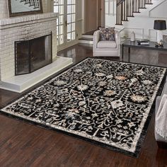 a living room with a fireplace and rug on the floor