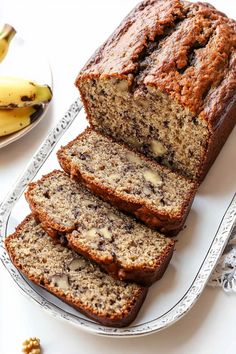 slices of banana bread on a plate next to bananas