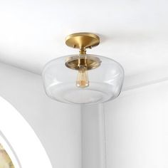 a light that is on the ceiling in a room with white walls and flooring