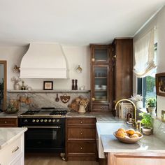 a kitchen with wooden cabinets and marble counter tops