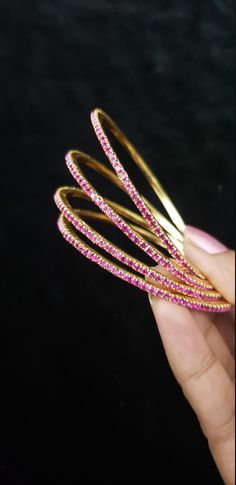 "* Handcrafted Gold Plated CZ Bangle Set * High Quality 22 K Gold Plated 4 pc bangle set; * 2.4 inches= ( 2.25\" diameter of the inner circle) ; 2.6 inches = ( 2.40\" diameter of the inner circle); 2.8inches = (2.54\" diameter of the inner circle) * Sold as a set of 4 bangles Gorgeous gold-plated bangle/ bracelet best exemplifies the careful craftsmanship done on it -- a specialty at Nemali Jewelry. It has special tone of elegance attached to it. The intricate handmade design of the bangle / bra Pink Hand Set Bracelets For Festivals, Pink Bangle Jewelry For Diwali, Pink Stone Work Bangle For Wedding, Temple Jewelry Style Round Bangle For Party, Temple Jewelry Style Bangle For Party, Temple Jewelry Bangle For Party, Pink Hand Set Bangle As A Gift, Pink Stackable Wedding Bangle, Traditional Bangles