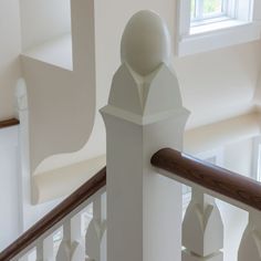 the railings and balconies in this house are all white with wood handrails