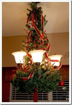 a chandelier decorated with christmas decorations and lights