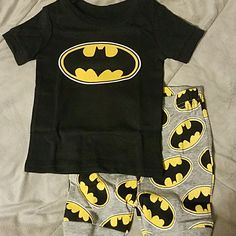 Short Sleeve Top In Black, With The Batman Sign And Shorts In Gray With All Over Batman Pattern. 12-18mo Black Graphic Print Playwear Sets, Black Graphic Print Sets For Playwear, Black Cotton Bottoms For Playtime, Black Letter Print Playwear Sets, Black Cotton Playtime Sets, Black Letter Print Sets For Playwear, Batman Pjs, Batman Pajamas, Batman Sign