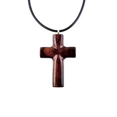 "Hand carved in Cocobolo, an exotic hardwood that originates from Mexico, this reversible wooden cross pendant is one of a kind. This particular exotic wood tends to darken over time, therefore by the time you will receive this pendant the wood might have settled into darker reddish-brown tones. The pendant is sealed with multiple layers of glossy wood lacquer that add a lot of shine to the piece. - This pendant measures approximately 1.5\" tall by 1\" wide (3.3cm by 2.5cm). - The pendant comes with an adjustable 18-20\" (47-51cm) black Korea waxed cord with lobster clasp, ready to wear. The waxed cord has a shinny snakeskin like texture and is a great non-fraying alternative to leather. For more hand carved WOOD CROSS PENDANTS please visit our entire section within the shop here: http://w Raven Necklace, Wood Cross, Wood Crosses, Wooden Cross, Brown Tones, Christian Jewelry, Reddish Brown, Hand Carved Wood, Wood Jewellery